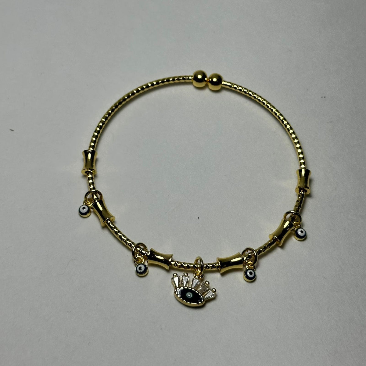 Pulsera abierta ojo en medio azul marino.oro