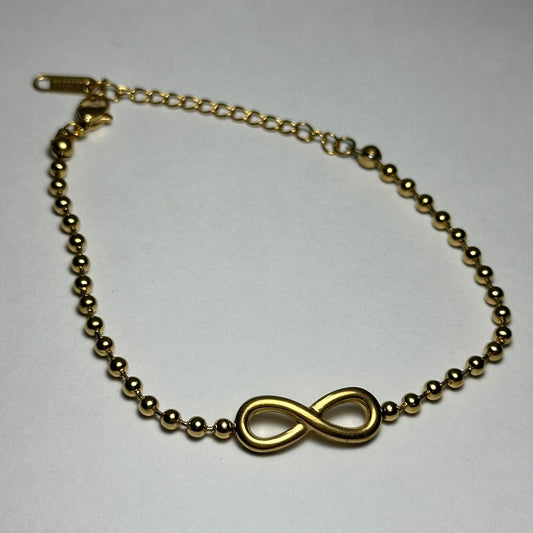 Pulsera bolitas con infinito en medio.oro