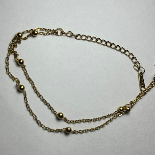 Pulsera doble con bolitas.oro
