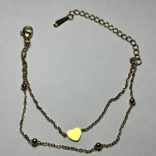 Pulsera doble, corazón en medio y bolitas.oro