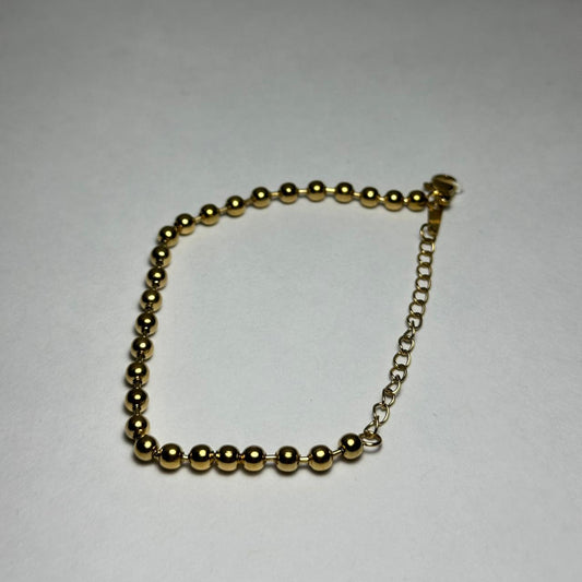 Pulsera simple de bolitas.oro