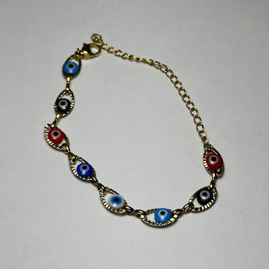 Pulsera simple ojitos de colores variados.oro