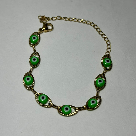 Pulsera simple ojitos verdes.oro
